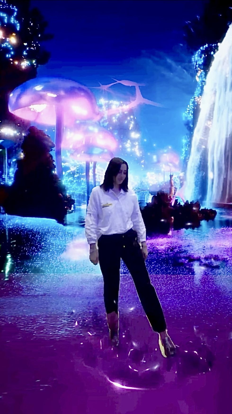 Person standing in a vibrant, dreamy, neon-lit fantasy landscape with mushrooms and waterfall.