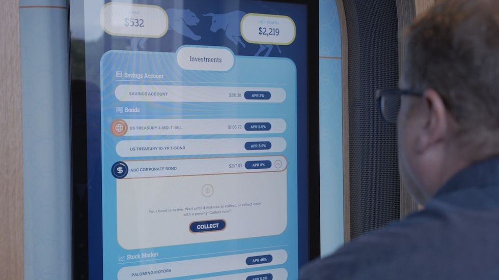 Person viewing an interactive investment screen displaying savings and bond options.