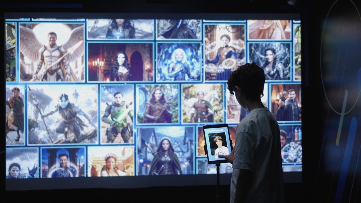 Person with a tablet viewing a Selfie Wall of fantasy character images.