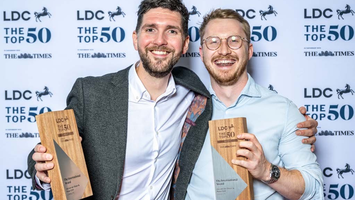 Peter Cliff & Jos van der Steen holding awards at LDC The Top 50 event.