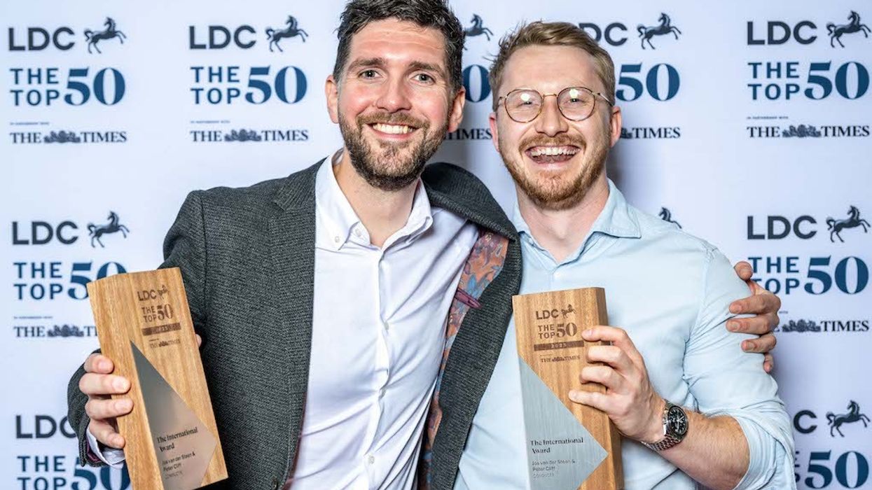 Peter Cliff & Jos van der Steen holding awards at LDC The Top 50 event.