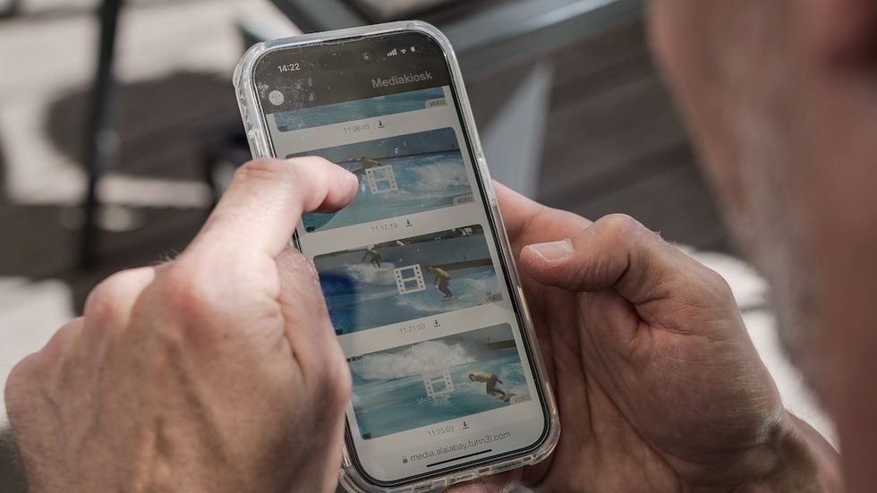 phone showing surf videos from CheckMySurf by wavegarden