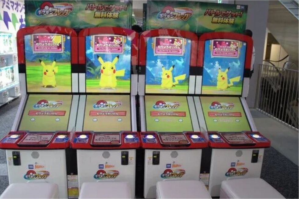 Pikachu arcade machines with colorful screens in a gaming area.