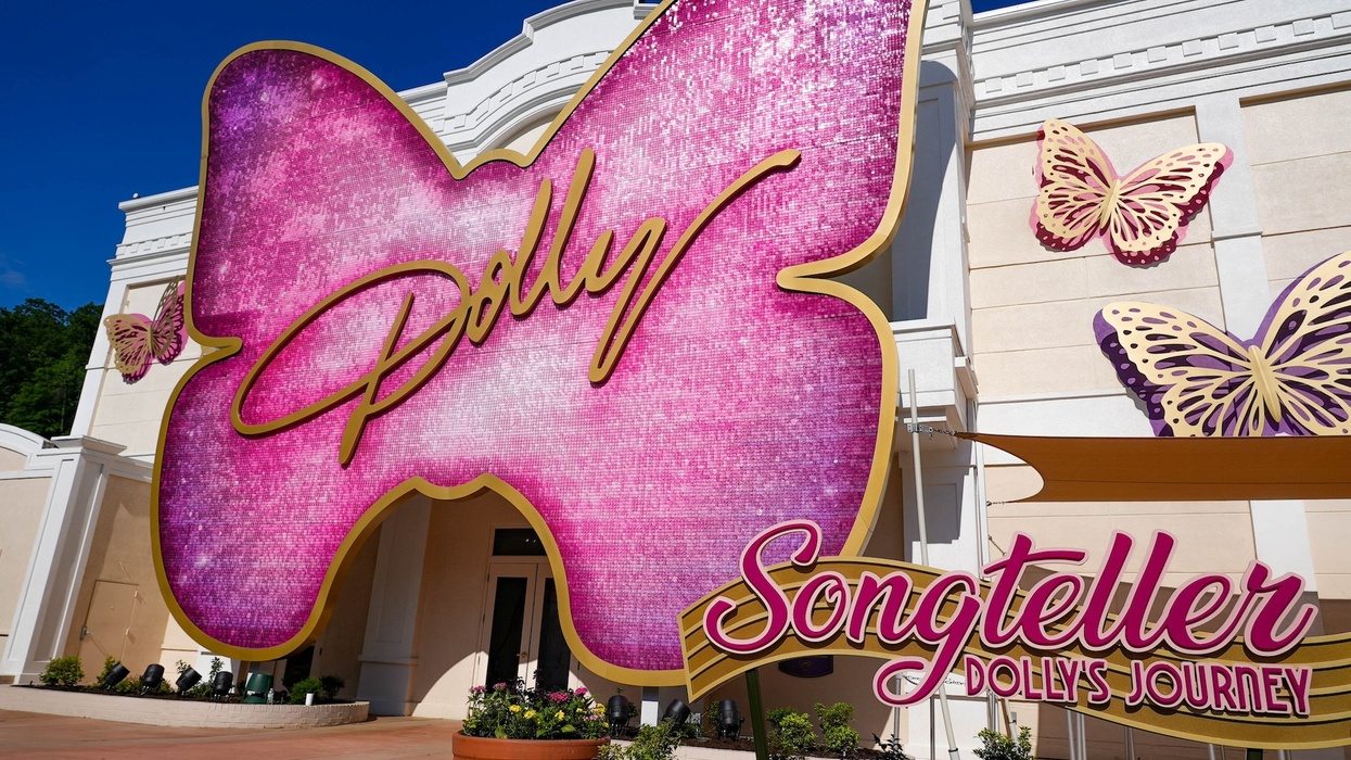 Pink butterfly-shaped sign reading "Dolly Songteller: Dolly's Journey" on a building facade.