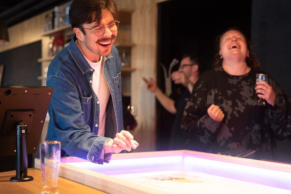 Playing shuffleboard at Shuffly showroom