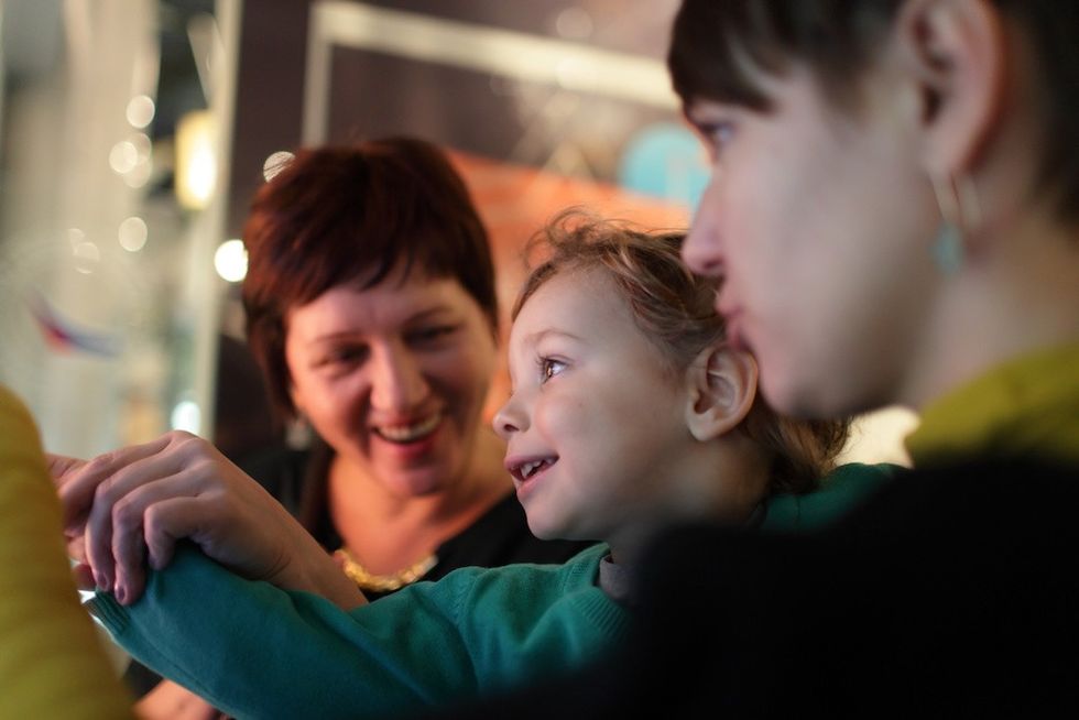 Portrait of happy family in a museum creating the visitor experience