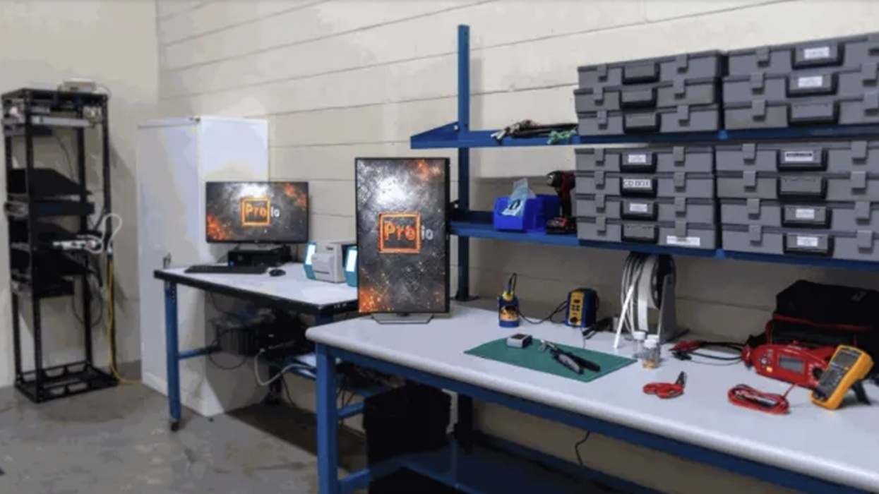 ProIO's new workshop with desks, tools, labeled containers, and computer monitors.