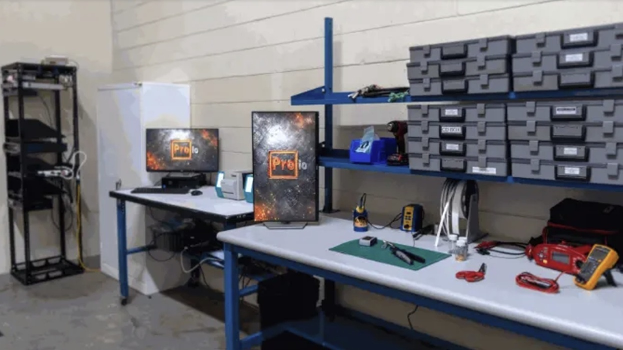 ProIO's new workshop with desks, tools, labeled containers, and computer monitors.