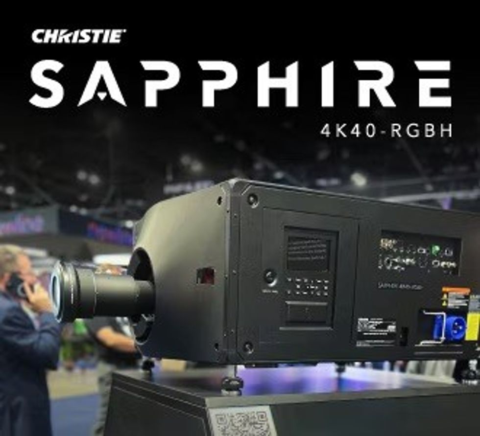 Projector display at an event, labeled "Christie Sapphire 4K40-RGBH".