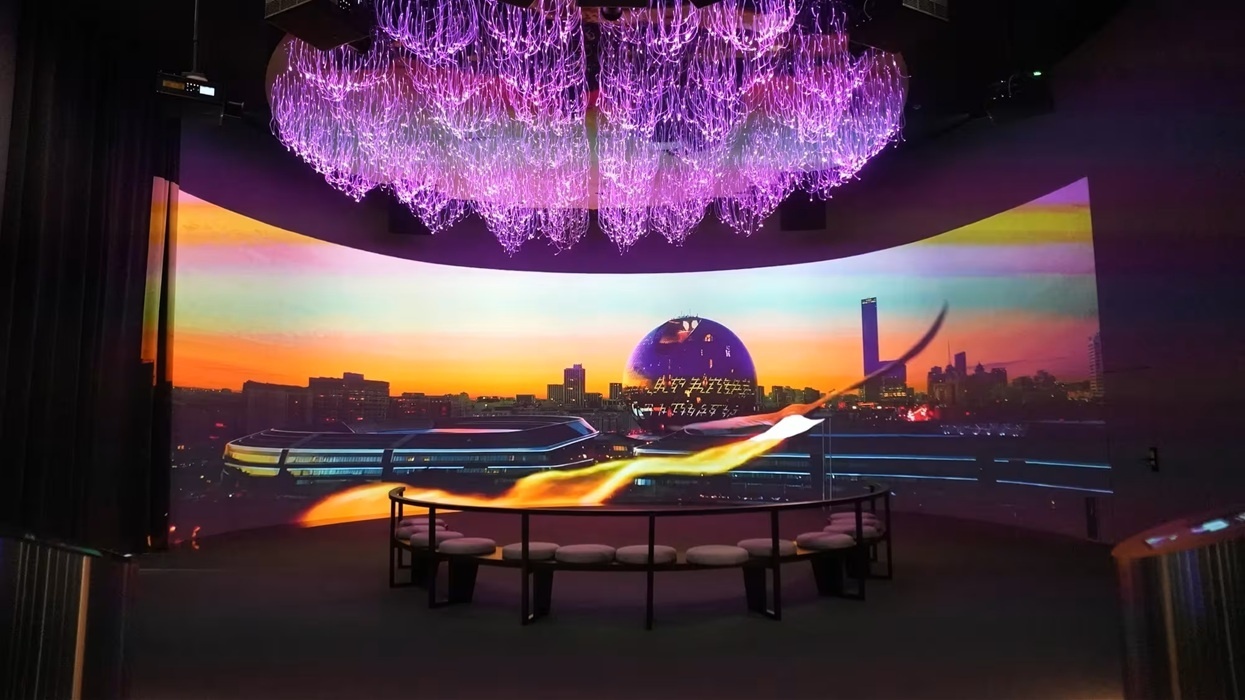 Purple chandelier above a panoramic cityscape display with a circular seating area at ALEM AI.