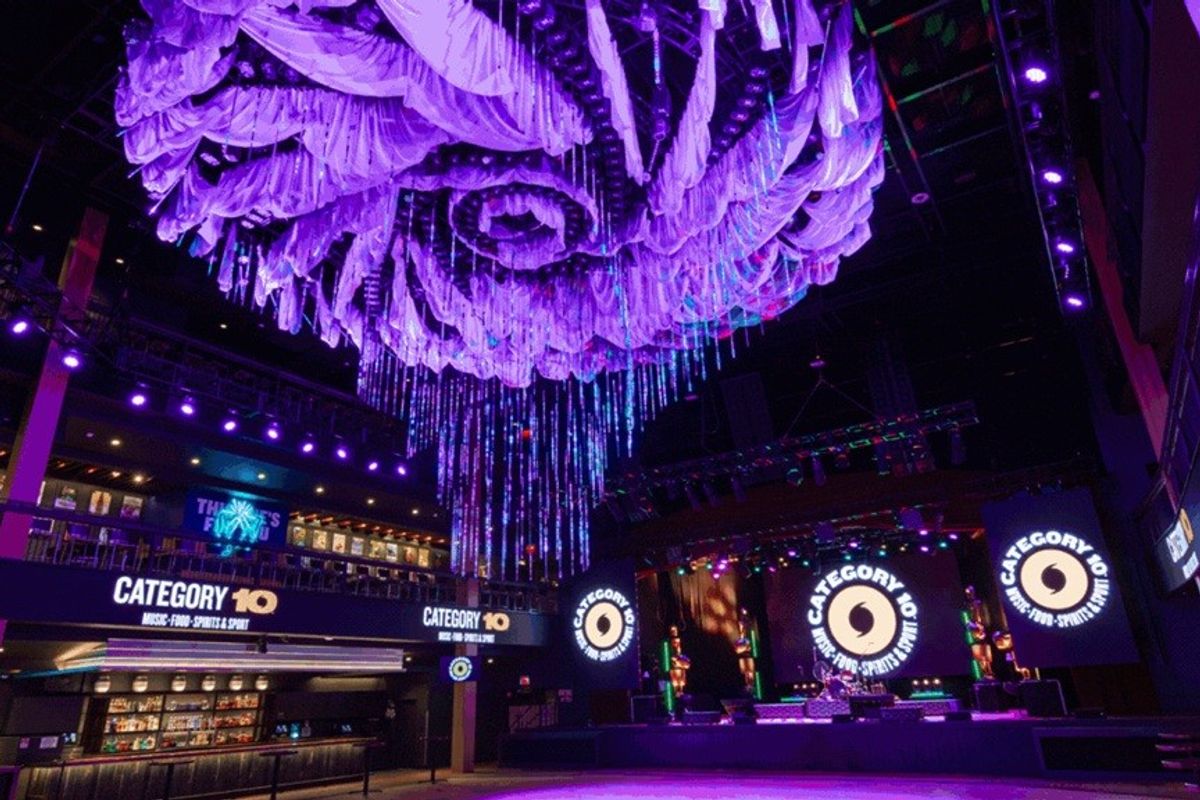 Purple-lit nightclub interior with large, ornate ceiling decorations.