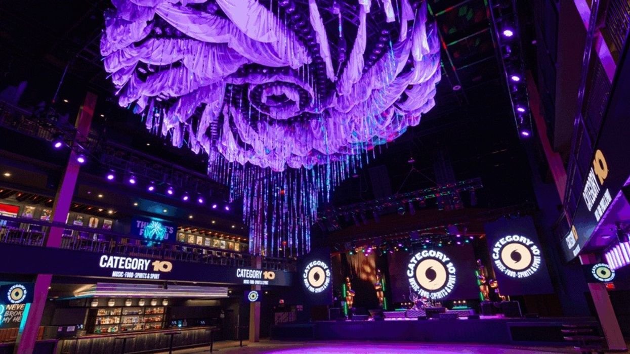 Purple-lit nightclub interior with large, ornate ceiling decorations.