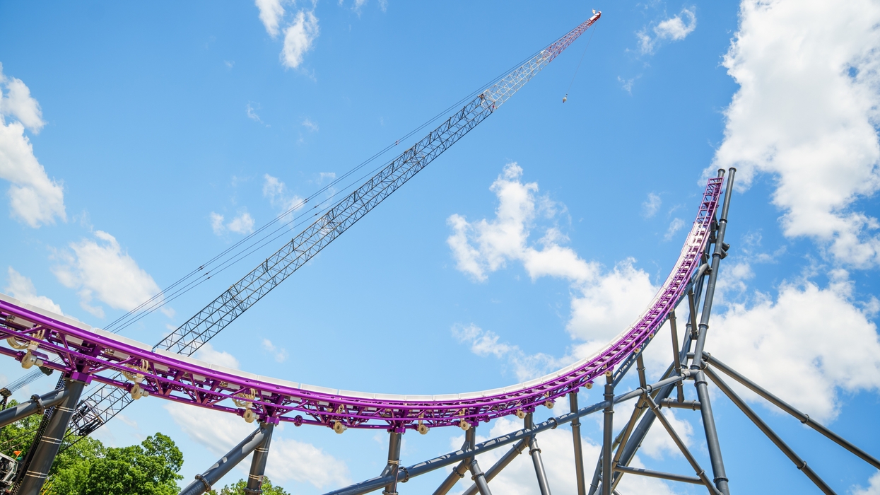 Purple roller coaster against a blue sky with clouds at Six Flags Great Adventure