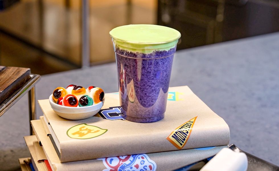 Purple smoothie cup and eyeball candies on school binders.