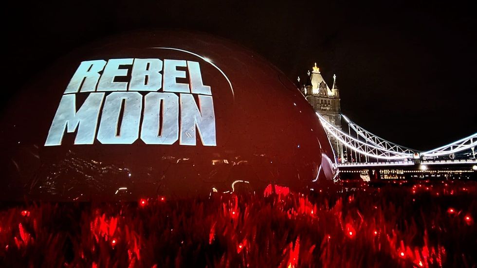 "Rebel Moon" projected on a dome near Tower Bridge at night.