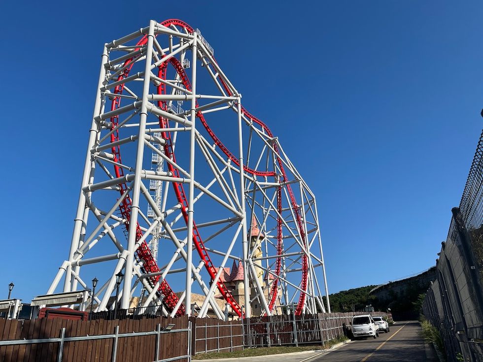 Red and white roller coaster, Zamperla Double Heart under a clear blue sky