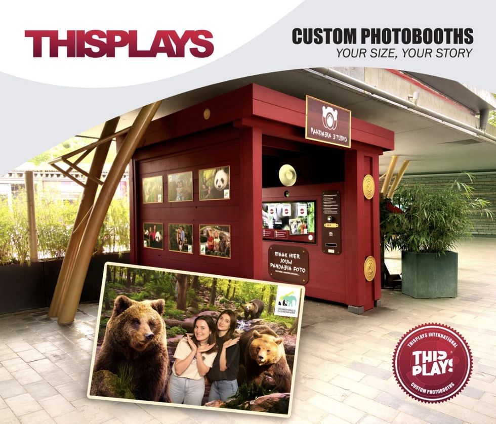 Red photobooth with wildlife photos and two people posing with bear images.
