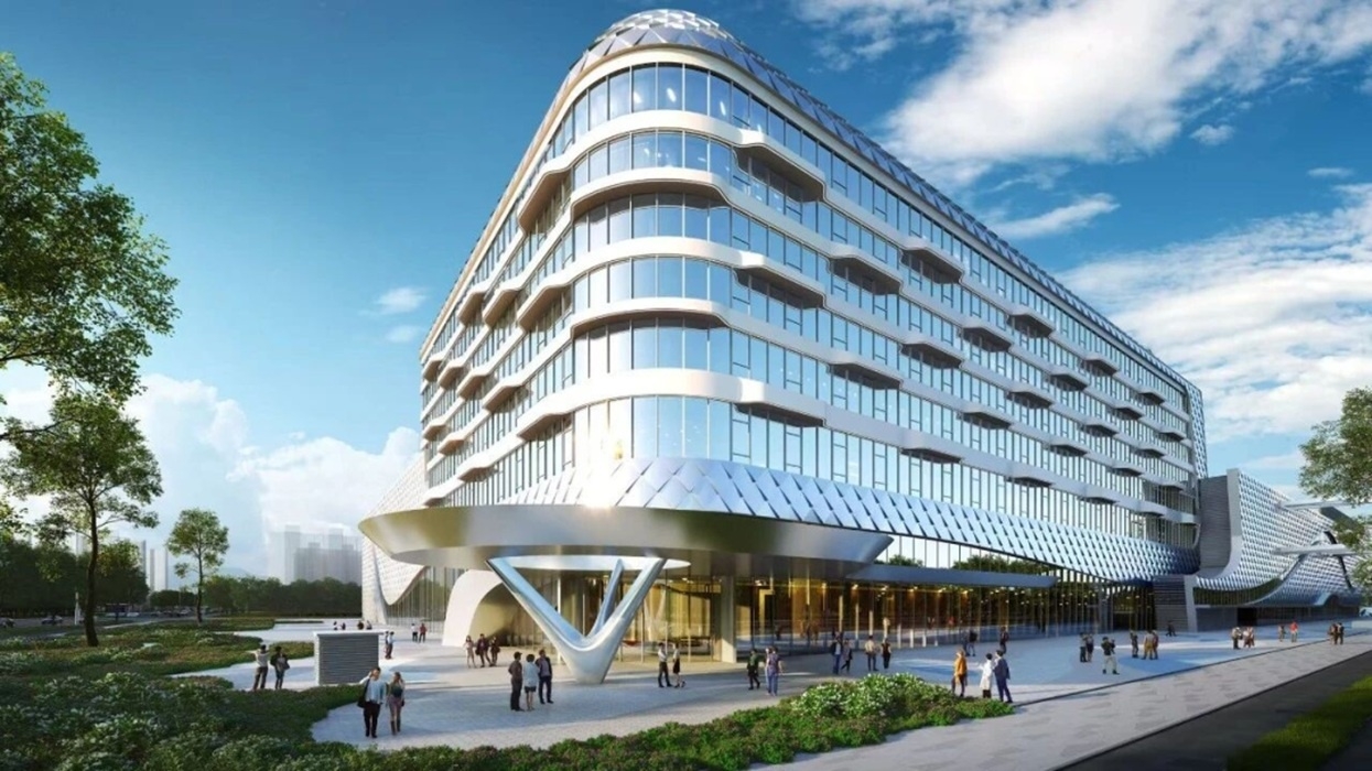 Render of Beijing Haichang Ocean Park, a modern, curved building with glass facade under a blue sky, surrounded by people and trees.