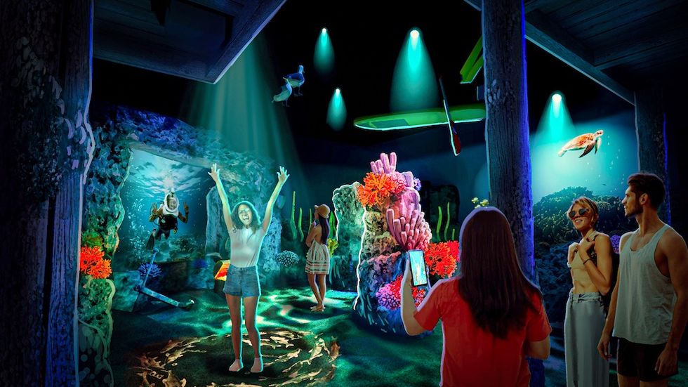 Rendering for Balashi Beer Experience shows people enjoying an interactive underwater-themed exhibit with vibrant coral and sea creatures.