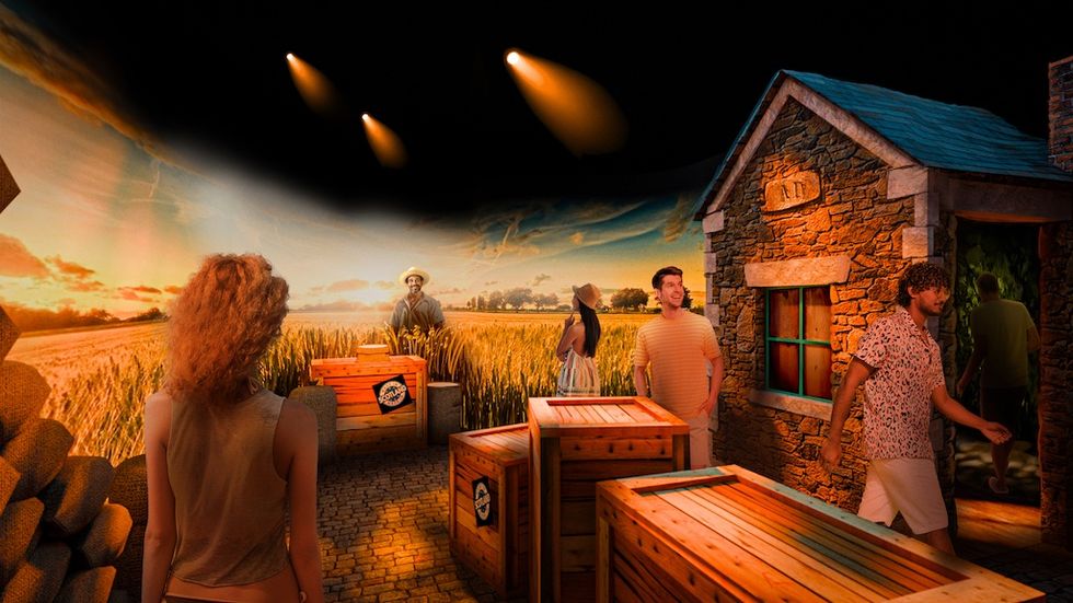 Rendering for Balashi Beer Experience shows people exploring a rustic, immersive farm exhibit with crates and a stone building, barley field