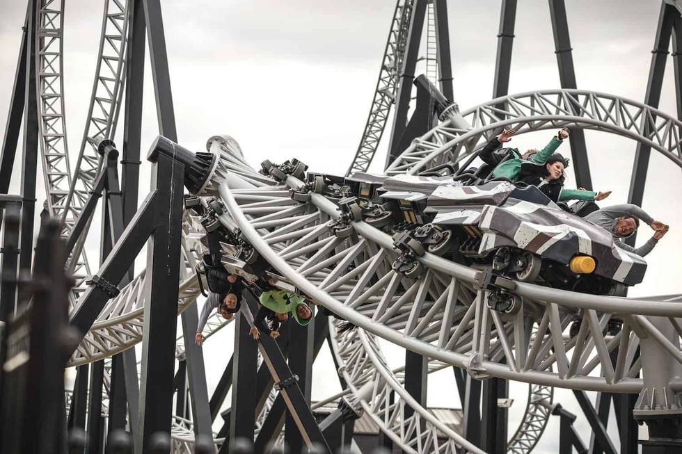 Riders thrill on Sik, a looping roller coaster at Flamingo Land with complex steel tracks and sharp curves.
