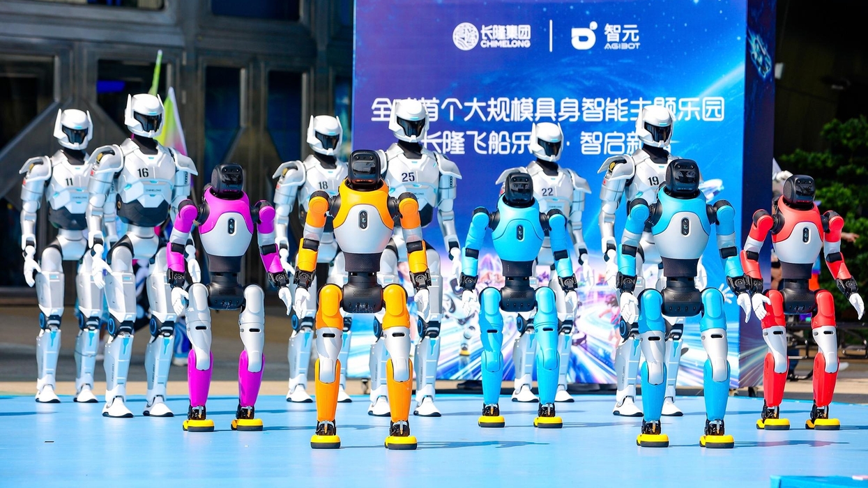 Robot lineup in colorful uniforms, standing on a stage with a blue backdrop at Chimelong Spaceship