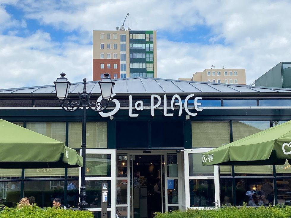 Roermond, Netherlands - July 1. 2021: View on building entrance with logo lettering of la place restaurant chain (focus on center)