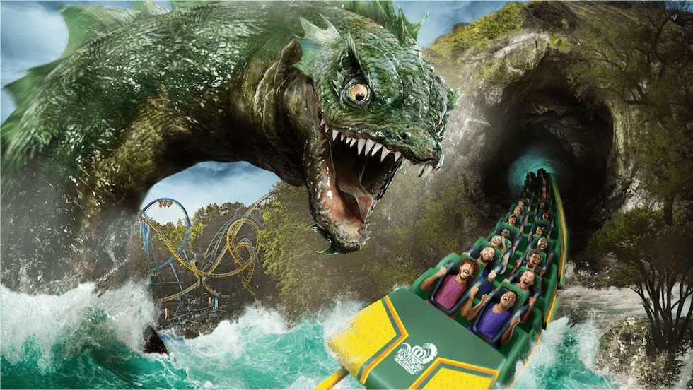 Roller coaster emerging from cave, facing a giant sea monster.