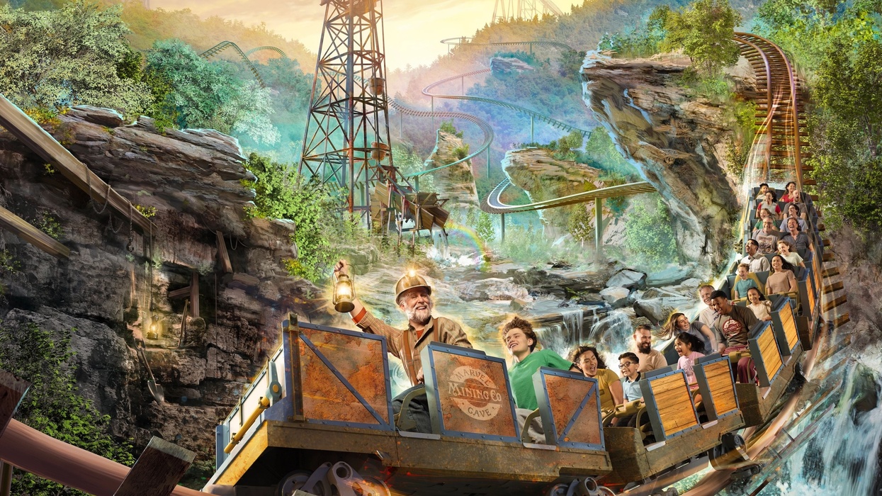 Roller coaster ride through forested mountains with excited passengers and a miner character at Silver Dollar City