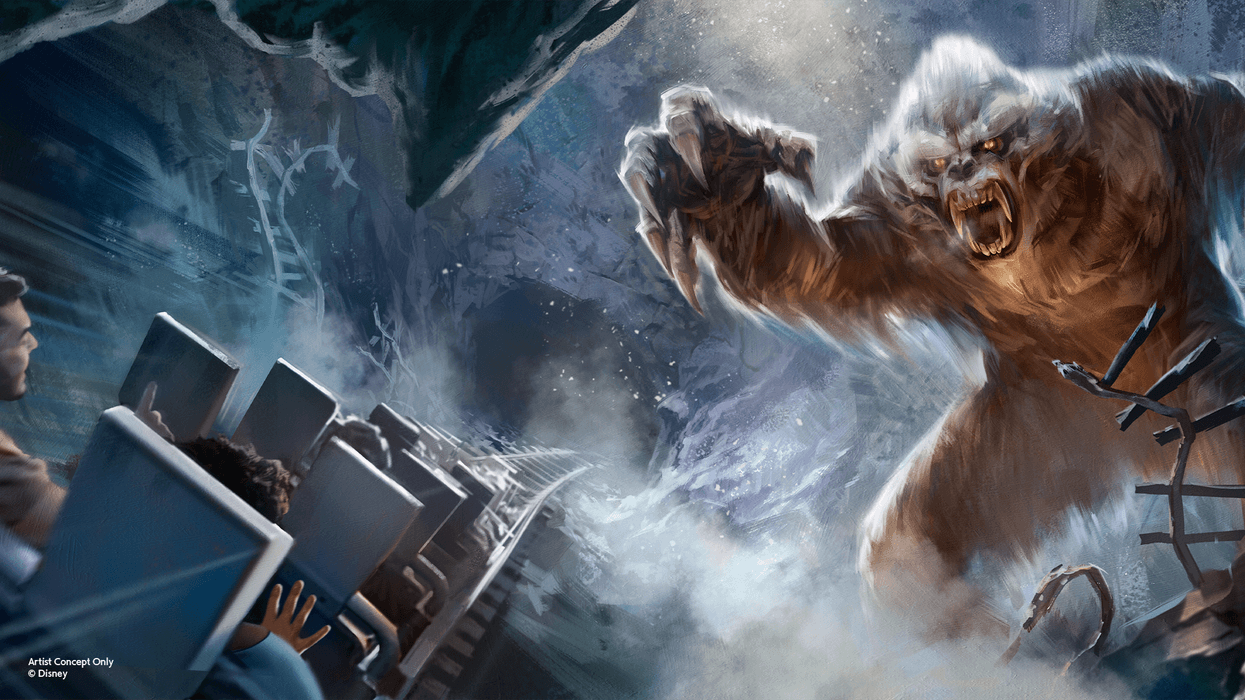 Roller coaster riders encounter a roaring yeti in a snowy cave at Disney's Animal Kingdom