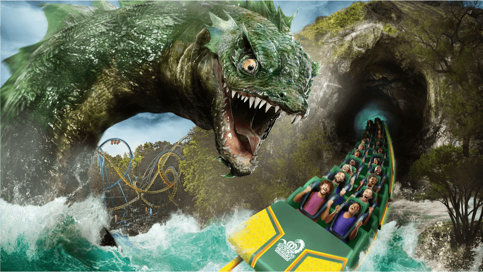 Roller coaster with giant sea monster emerging from waves, riders in a tunnel.