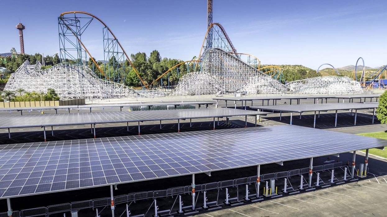 Roller coaster with solar panel-covered parking area at Six Flags Magic Mountain