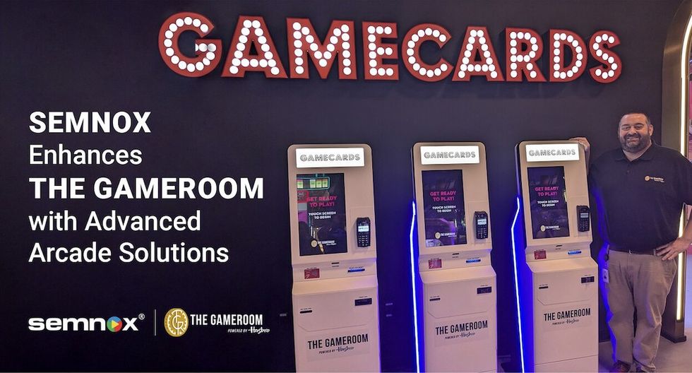 Ron Drakas, General Manager of The Gameroom, stands next to the newly installed Self-Service Kiosk
