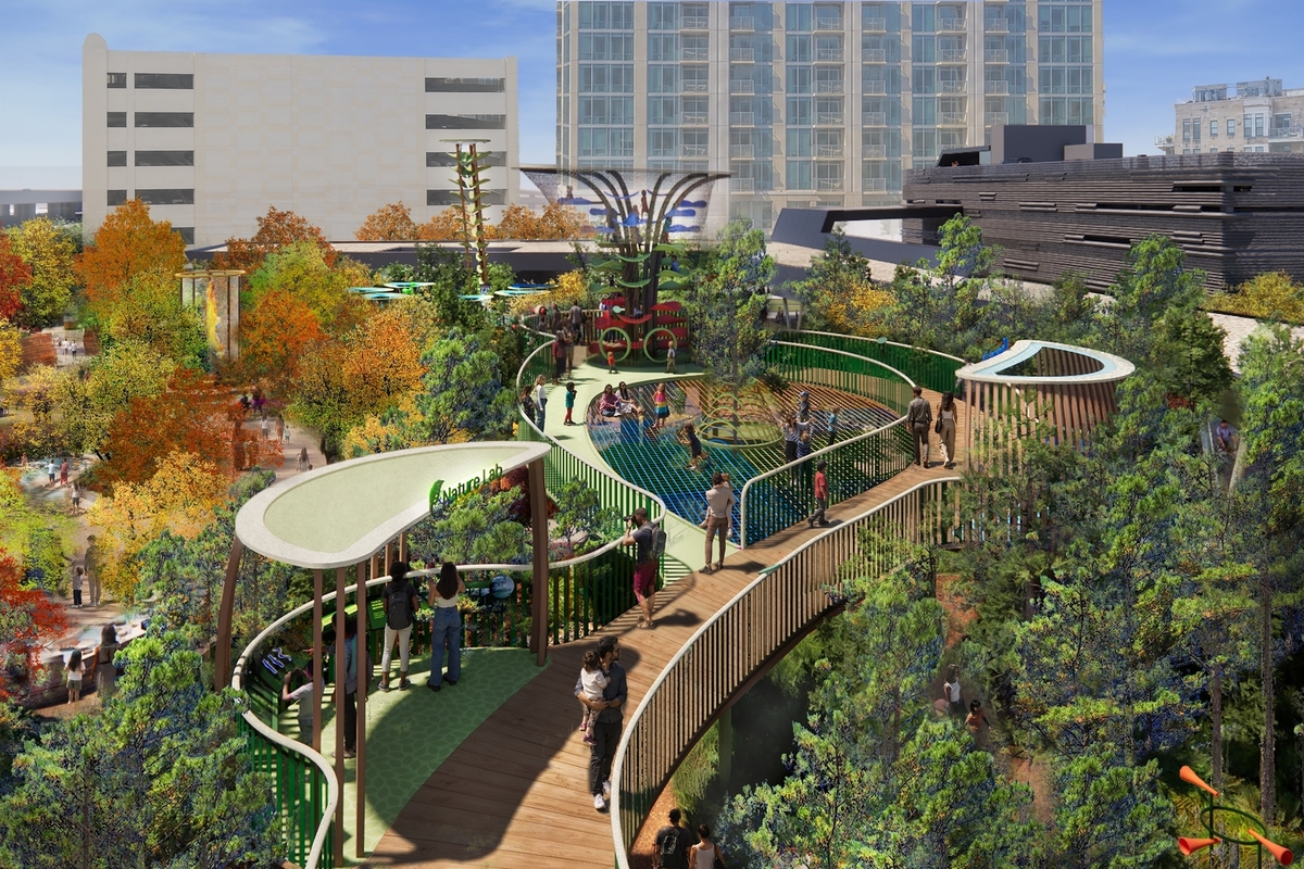 Rooftop park with walkways, trees, and people surrounded by city buildings at the Perot Museum