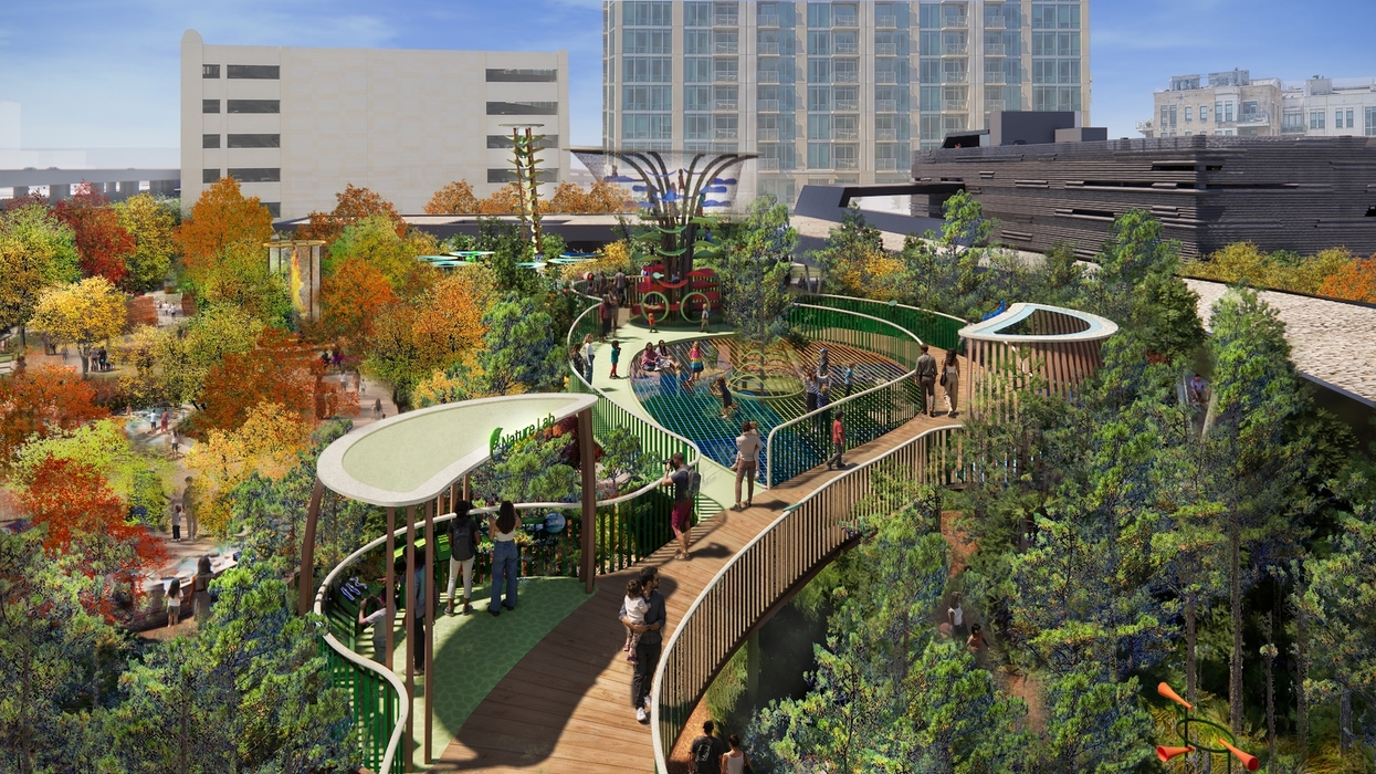 Rooftop park with walkways, trees, and people surrounded by city buildings at the Perot Museum
