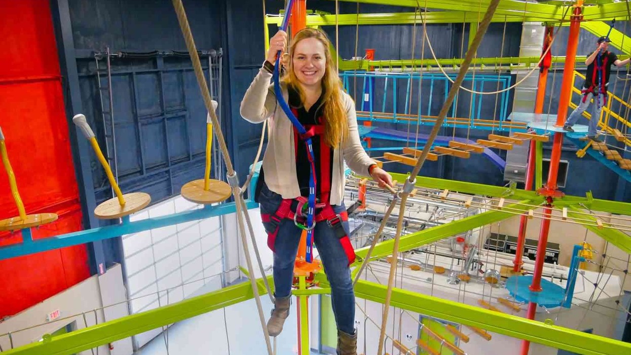 ropes courses woman tries out single redundant slingline