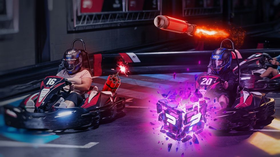 RPM Raceway's Kart Klash Two go-karts racing with virtual power-ups and projectile effects displayed.