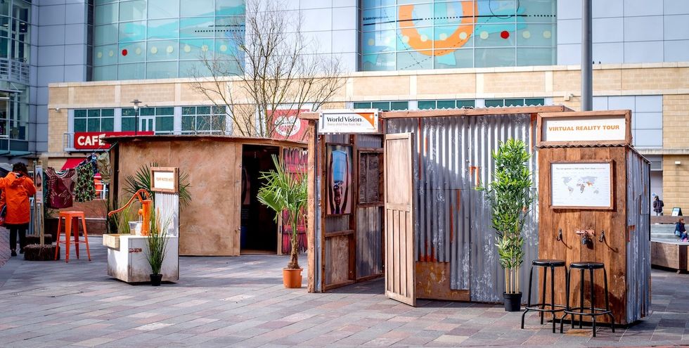 Rustic outdoor display for a virtual reality tour in a public square.