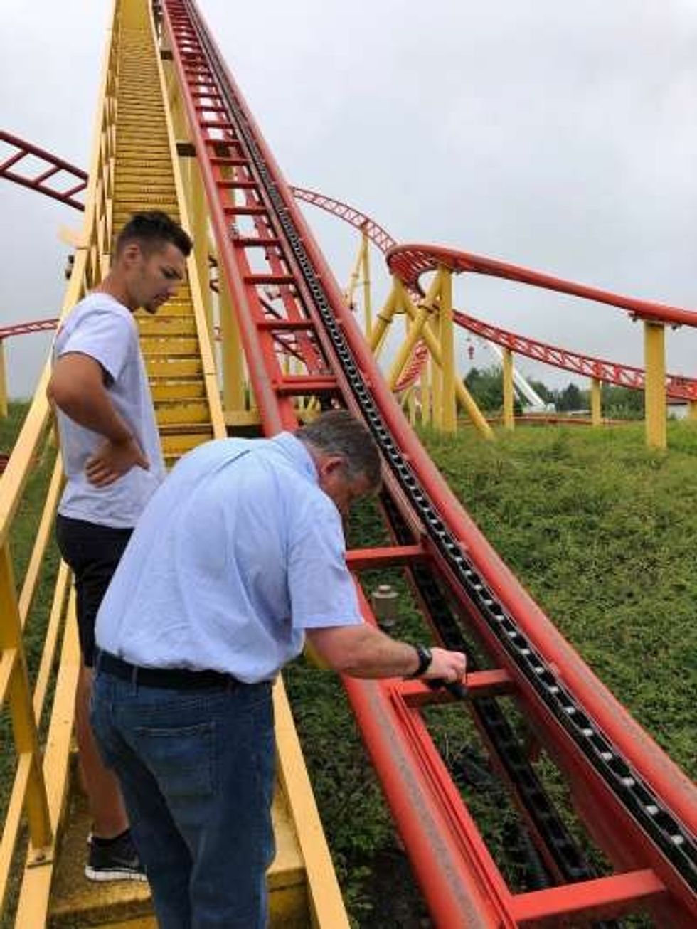 schwaben park germany - two men performing mobaro safety checks on coaster