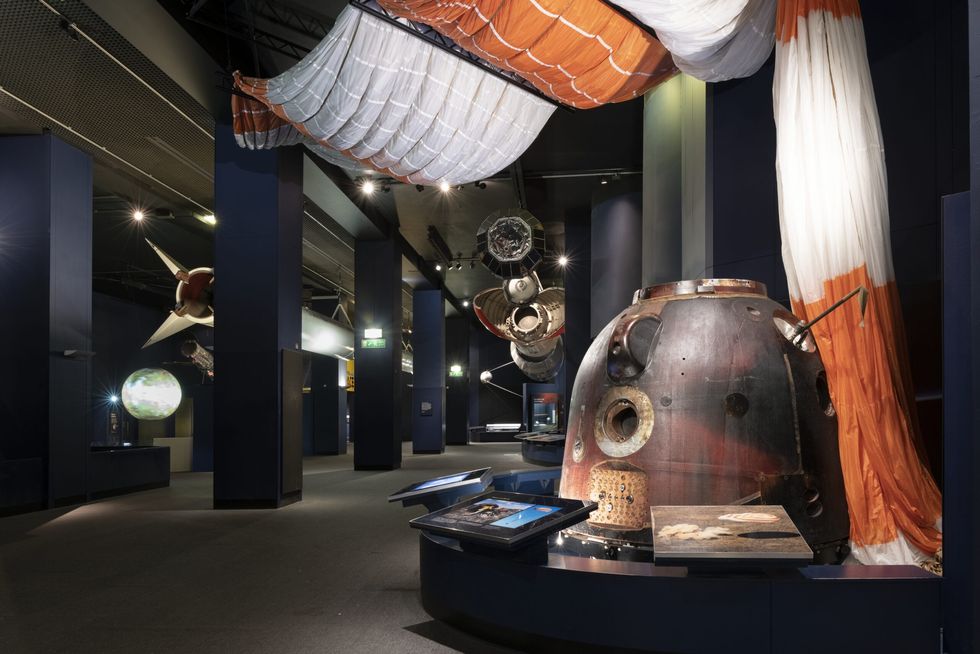 Science Museum exhibit with a space capsule and a large parachute displayed prominently.
