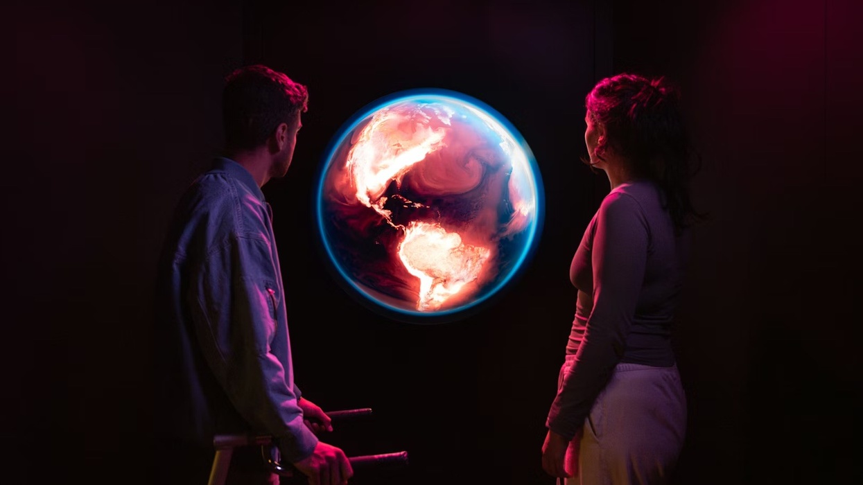 Science Museum Group - YOU:MATTER. Two people gaze at an illuminated globe in a dark, ambient setting.