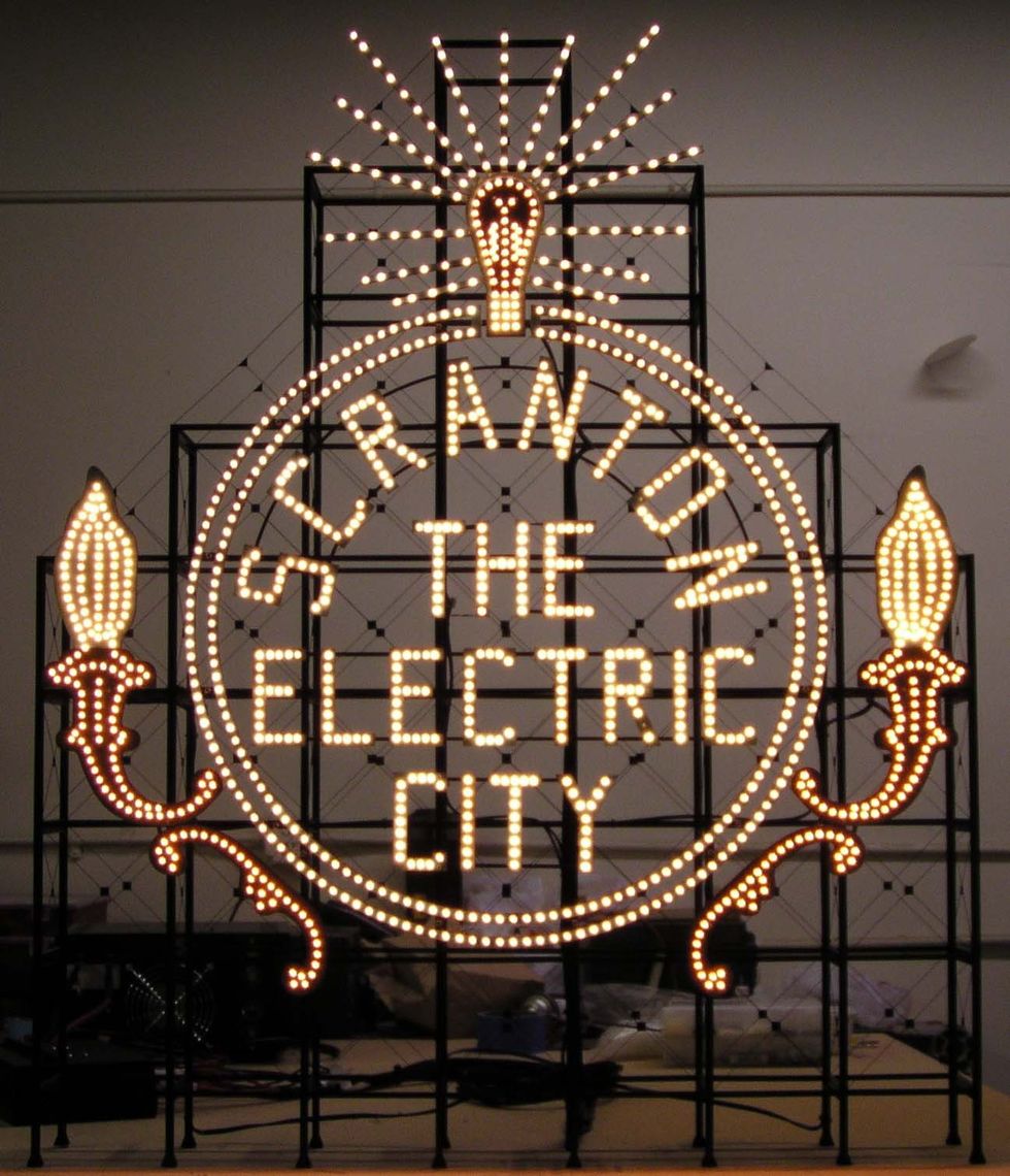 Scranton "The Electric City" illuminated sign with lightbulb shapes and ornate designs.