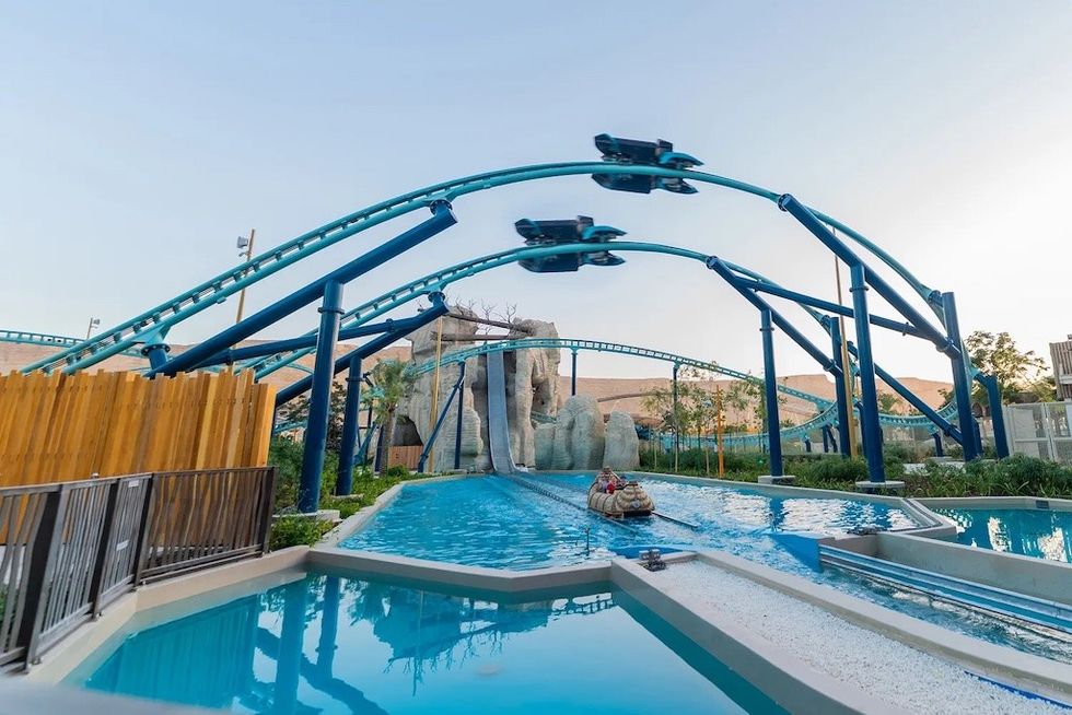 Sea Stallion roller coaste above log flume ride at an amusement park, parallel coaster cars racing