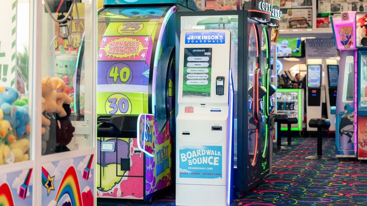 Semnox card machine at Jenkinson's Boardwalk. Vibrant arcade with colorful games, claw machines, and patterned flooring.