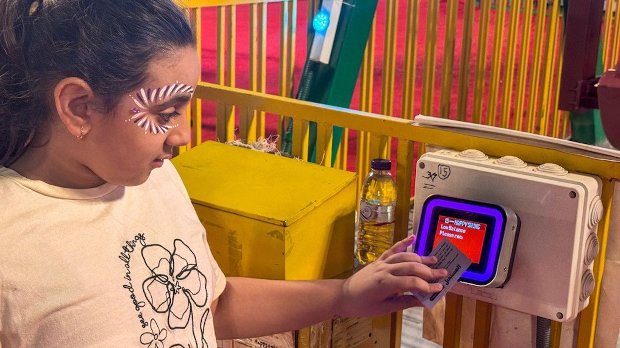Semnox Kid tapping RFID card to access ride