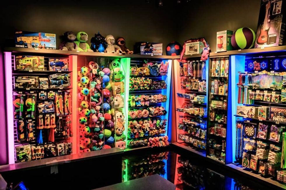 Shelves of Redemption Plus toys at Amusement Expo 2020