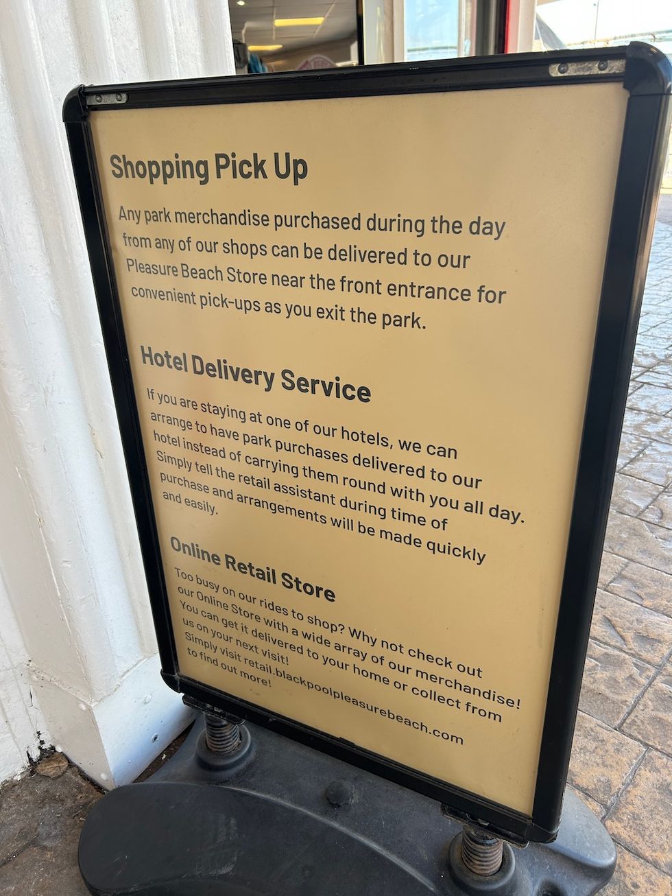 Sign detailing shopping pick-up and delivery services at a theme park.