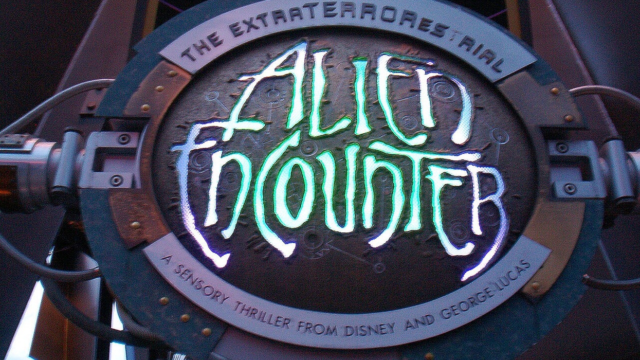 Sign for "Alien Encounter" attraction with glowing text and futuristic design.