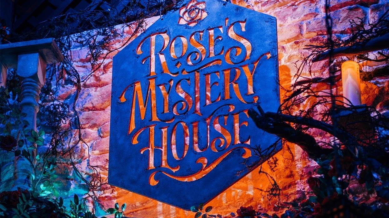Sign reading "Rose's Mystery House" with eerie, colourful lighting and vines.
