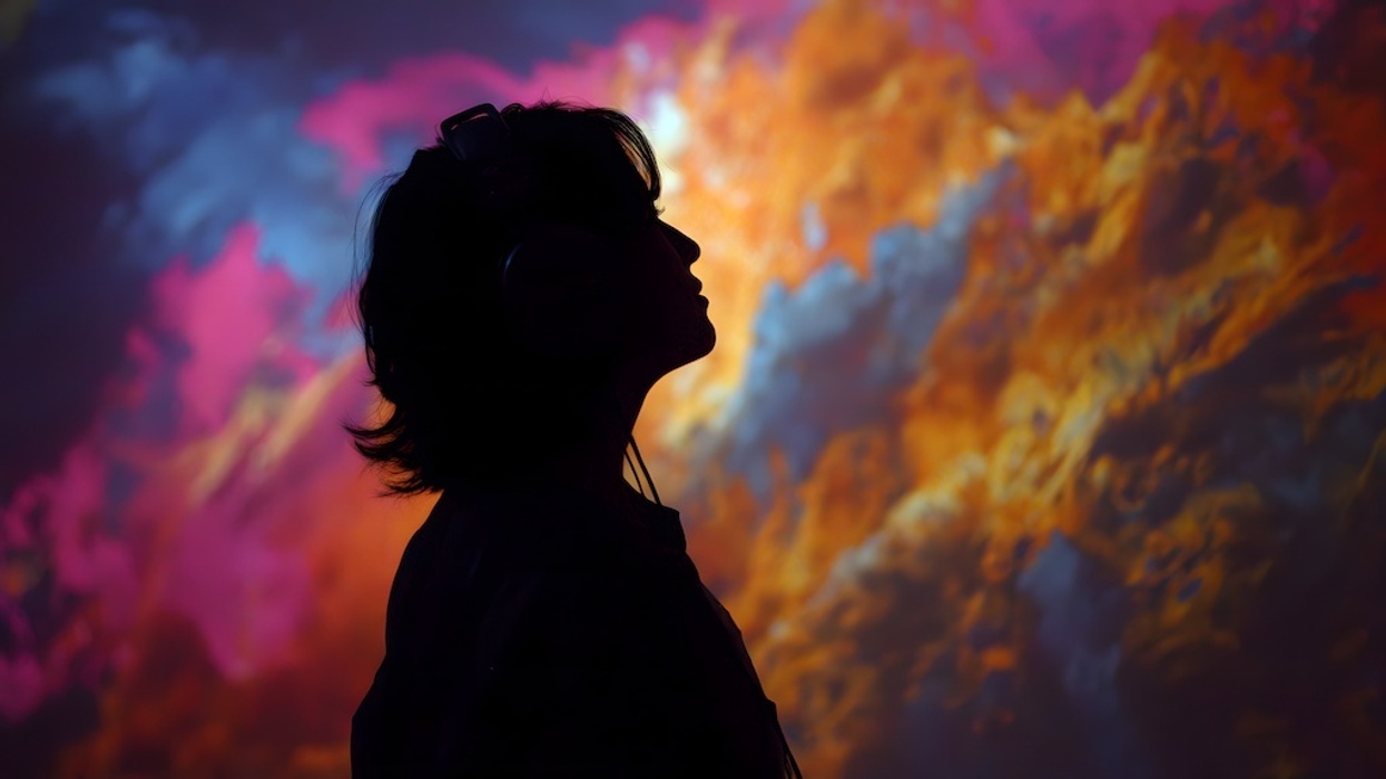 Silhouette of person wearing headphones, colorful abstract background, immersive experience